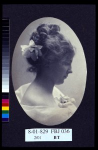 Oval portrait of woman with a flower in her hair and a corsage on her dress) - Miss Elton, Cleveland, Ohio LCCN2004676216