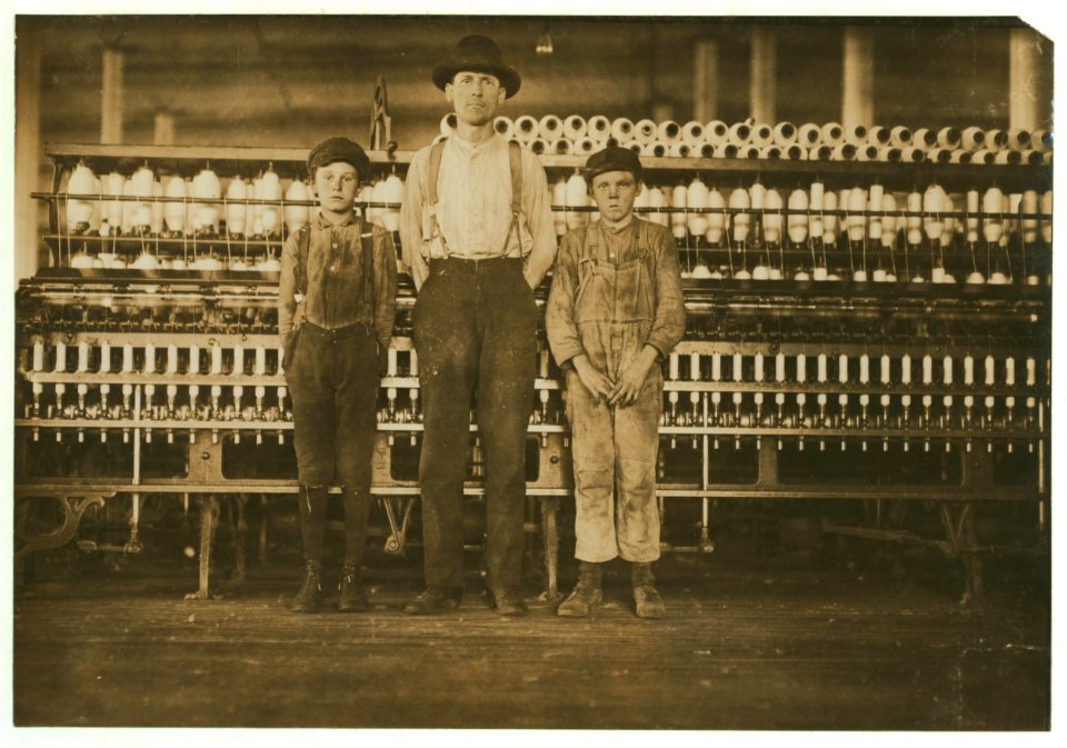 Overseer and two of the doffer boys, Charles Hennessy and John Douglass in Avondale Mills. Noon hour. Overseer said, 'we've got 30 of 'em.' LOC cph.3b21310