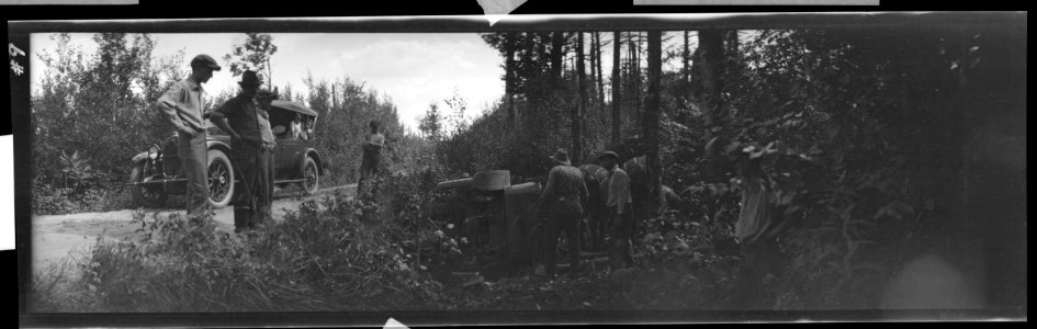 Overturned automobile with horse team trying to right it LCCN2017645742