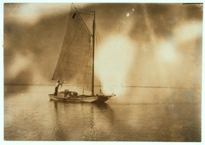 Oyster boat with load coming up to the barge to unload. LOC nclc.04683