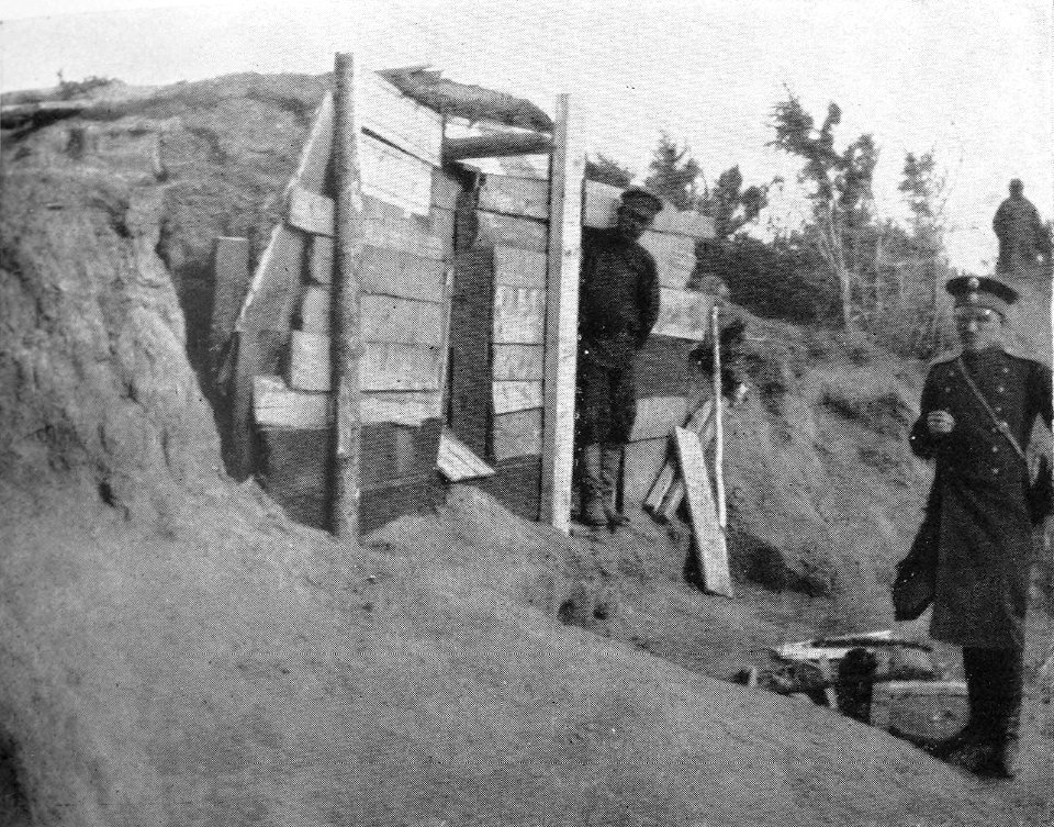 P217a Released convict in his cave dug out of the sandhill.The Pristav on the right
