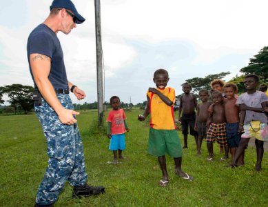Pacific Partnership Sailors from USNS Mercy interact with local children during their arrival in Arawa, Papua New Guinea 150622-N-CF750-058