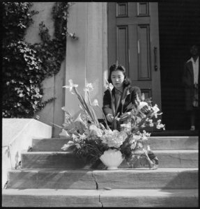 Oakland, California. Arranging flowers for alter on last day of services at Japanese Independent Co . . . - NARA - 536432