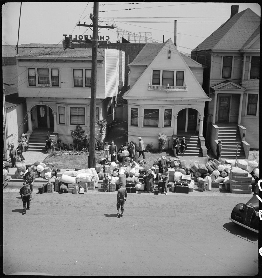 Oakland, California. Baggage of evacuees of Japanese ancestry piled on the sidewalk. The Greyhound . . . - NARA - 537701
