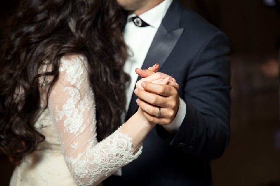 Groom bride holding hands