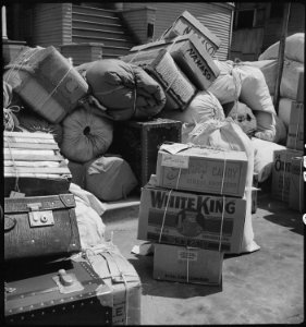 Oakland, California. This family of Japanese ancestry, is waiting at the Wartime Civil Control Admi . . . - NARA - 537704