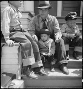 Oakland, California. Residents of Japanese ancestry waiting for evacuation buses which will take th . . . - NARA - 537707 photo