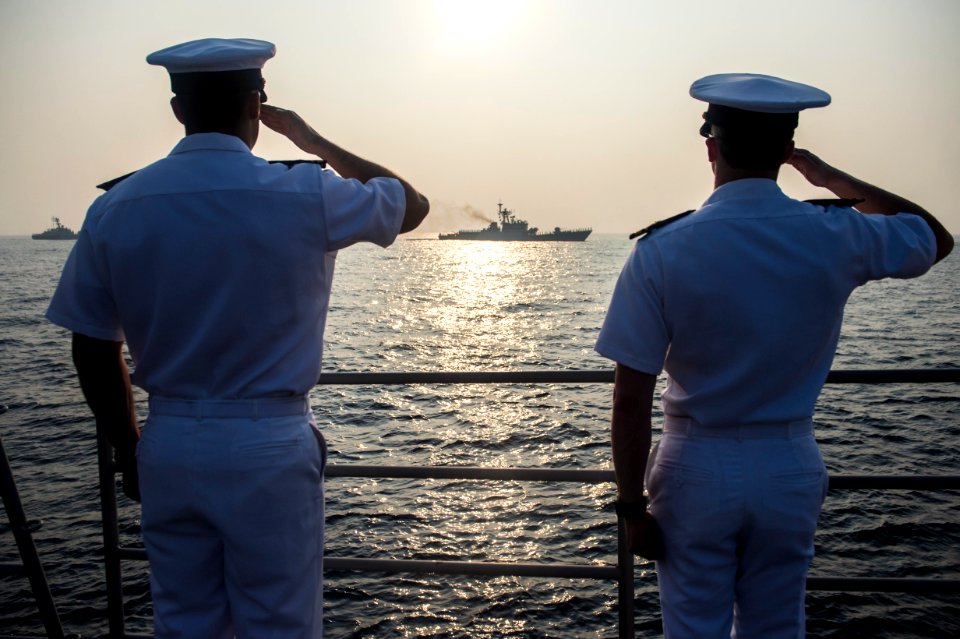 Officers assigned to the Ticonderoga-class guided-missile cruiser USS Antietam (CG 54) render honors to a column of Indian naval vessels to mark the conclusion of India’s International Fleet Review (IFR) 2016