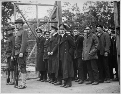 Officers and crew of the German submarine U.58, captured by the U.S.S. Fanning, entering the War Prison Camp at Fort... - NARA - 533462 photo