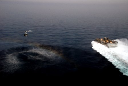 A UH-1Y Huey helicopter and an LCAC operate together. (8622943238)