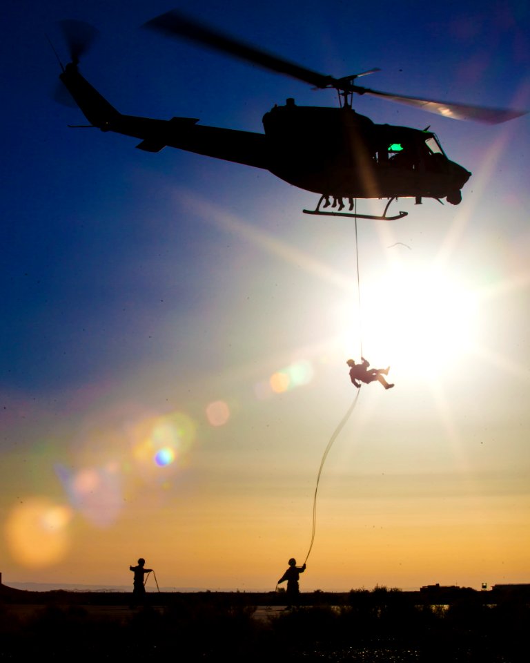 A U.S. Marine rappels from a UH-1N Huey helicopter. (9084856831)