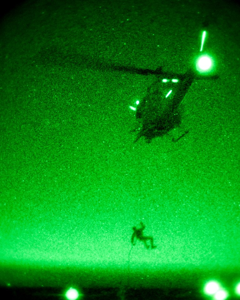 A U.S. Marine rappels from a UH-1N Huey helicopter. (9087077004)