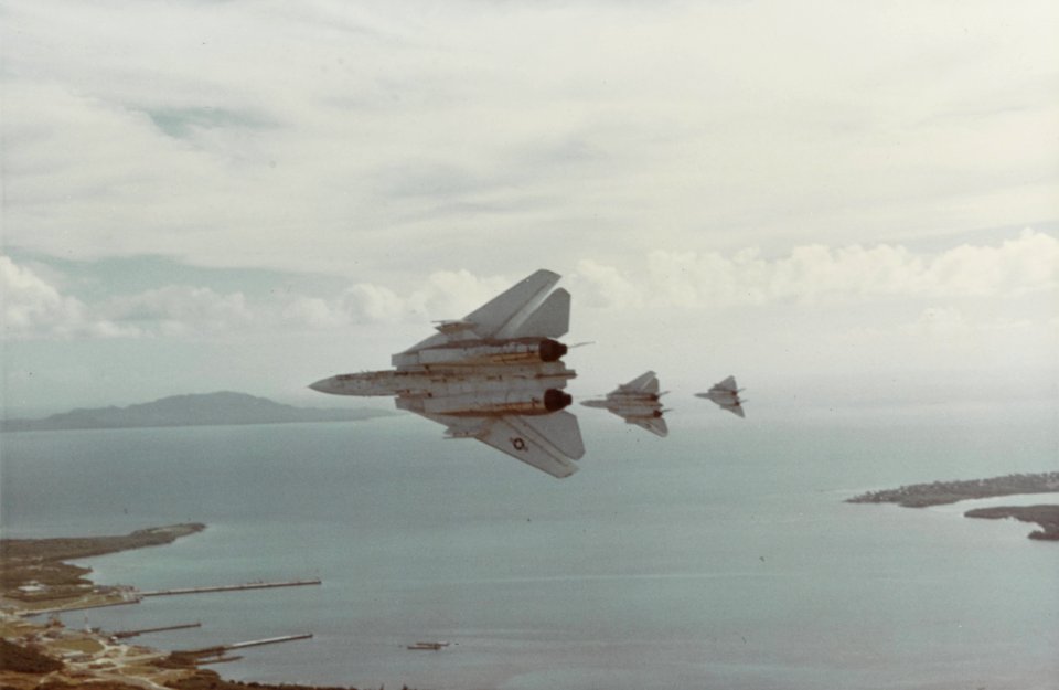 Grumman F-14 Tomcat's Peel off in formation over a unknown harbor August 1979. (50978402968)