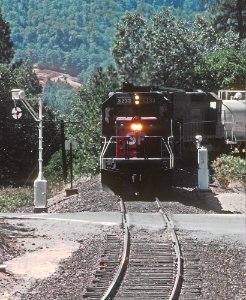 SP 8233 and a wigwag slightly south of Hugo, OR at the Three Pines Road crossing in July 1982 (33081929532)