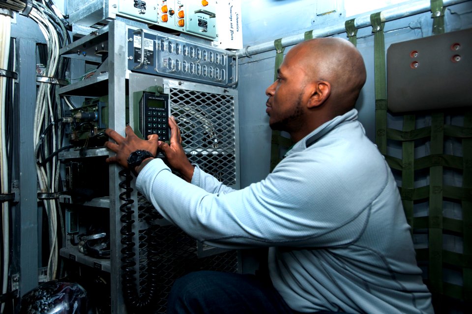 A technician tests a new communication system aboard USS Kearsarge. (8448061918)