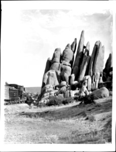 A train passes The Spires in the valley of Granite Dells near Prescott, Arizona, ca.1900 (CHS-4602)