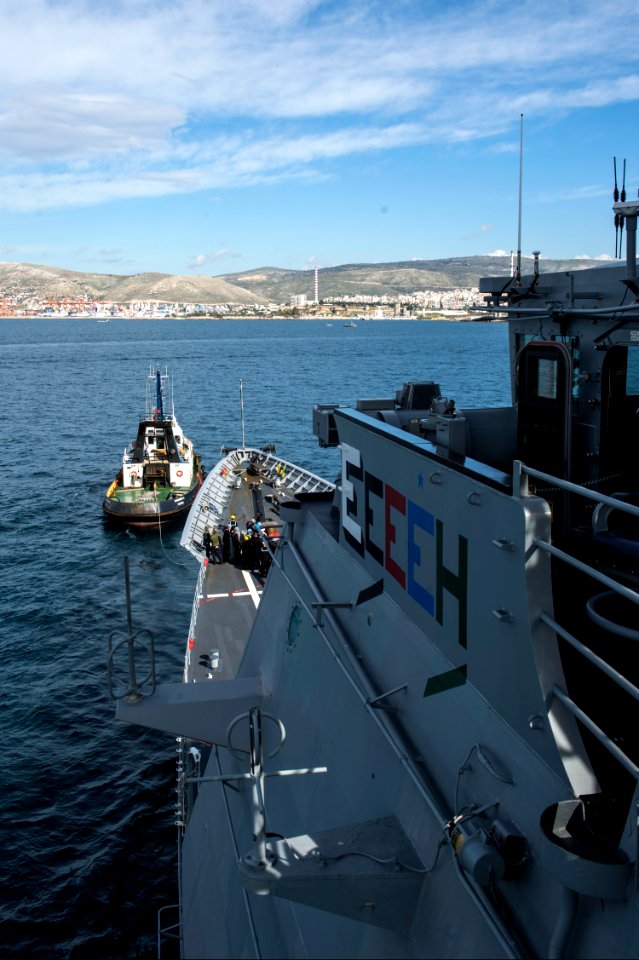 A tug boat pulls the guided missile cruiser USS Philippine Sea (CG 58) into Piraeus, Greece, for a scheduled liberty port visit March 4, 2014 140304-N-PJ969-257