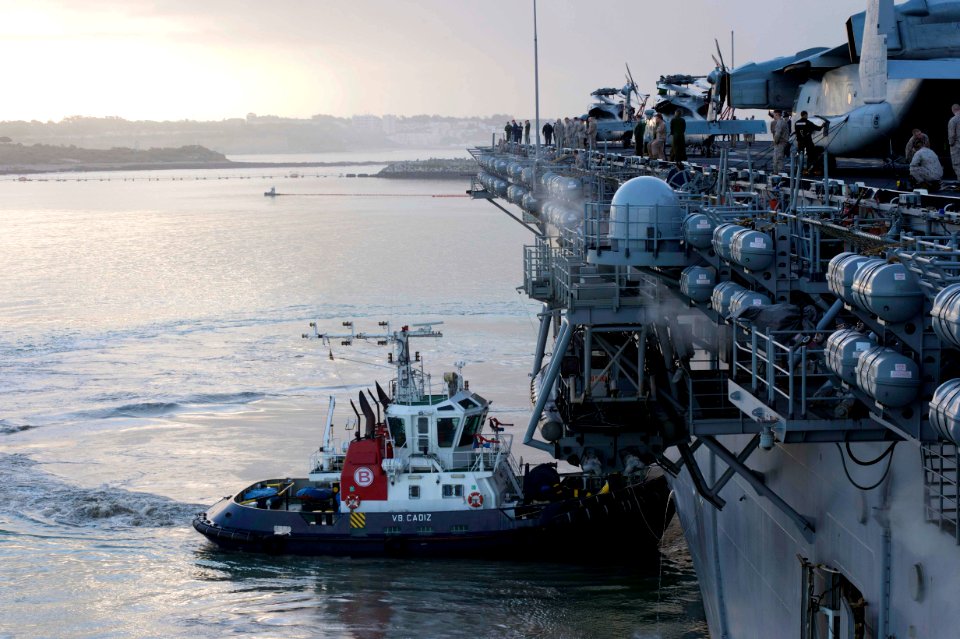 A tugboat helps USS Kearsarge enter port. (8597781188)