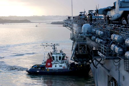 A tugboat helps USS Kearsarge enter port. (8597781188)