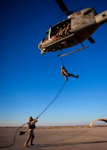 A U.S. Marine rappels from a UH-1N Huey helicopter. (9084857103)