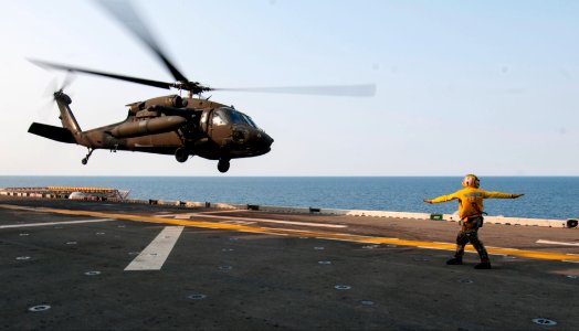A U.S. Army UH-60L Black Hawk helicopter assigned to the 3rd General Support Aviation Battalion, 2nd Combat Aviation Brigade, 2nd Infantry Division takes off from the amphibious assault ship USS Bonhomme Richard 140411-N-LM312-071 photo