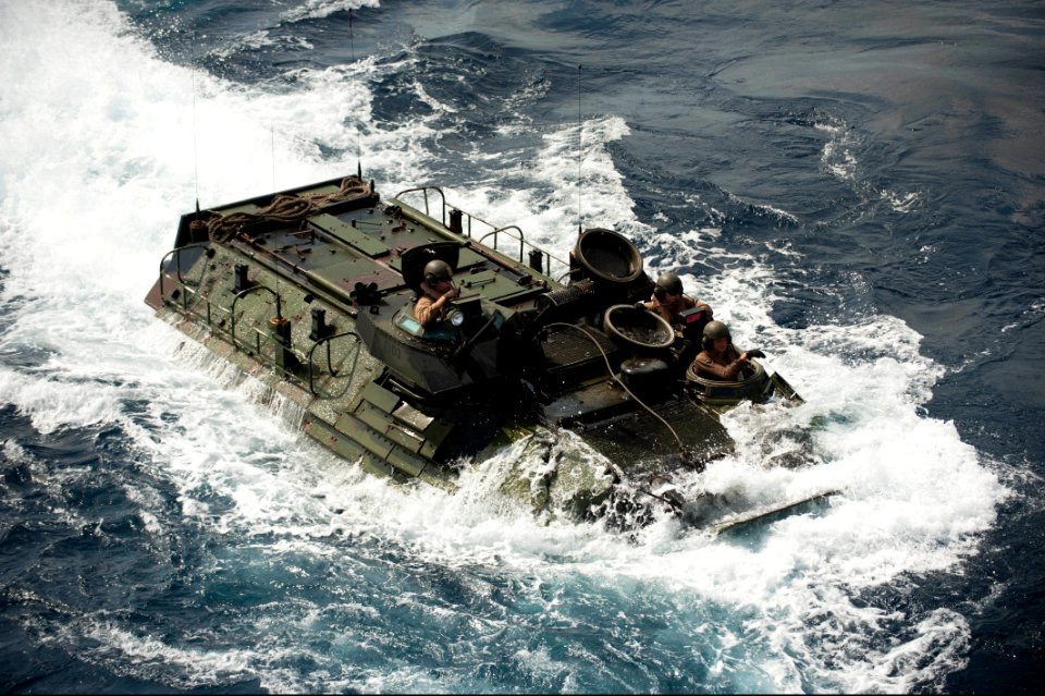 A U.S. Marine Corps assault amphibious vehicle prepares to enter the well deck of the amphibious assault ship USS Bonhomme Richard (LHD 6) in the East China Sea March 11, 2014 140311-N-LM312-248