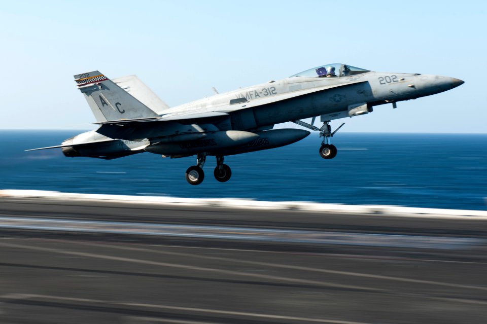 A U.S. Marine Corps F-A-18C Hornet aircraft assigned to Marine Fighter Attack Squadron (VMFA) 312 launches from the flight deck of the aircraft carrier USS Harry S. Truman (CVN 75) in the Gulf of Oman March 14 140314-N-ZG705-124