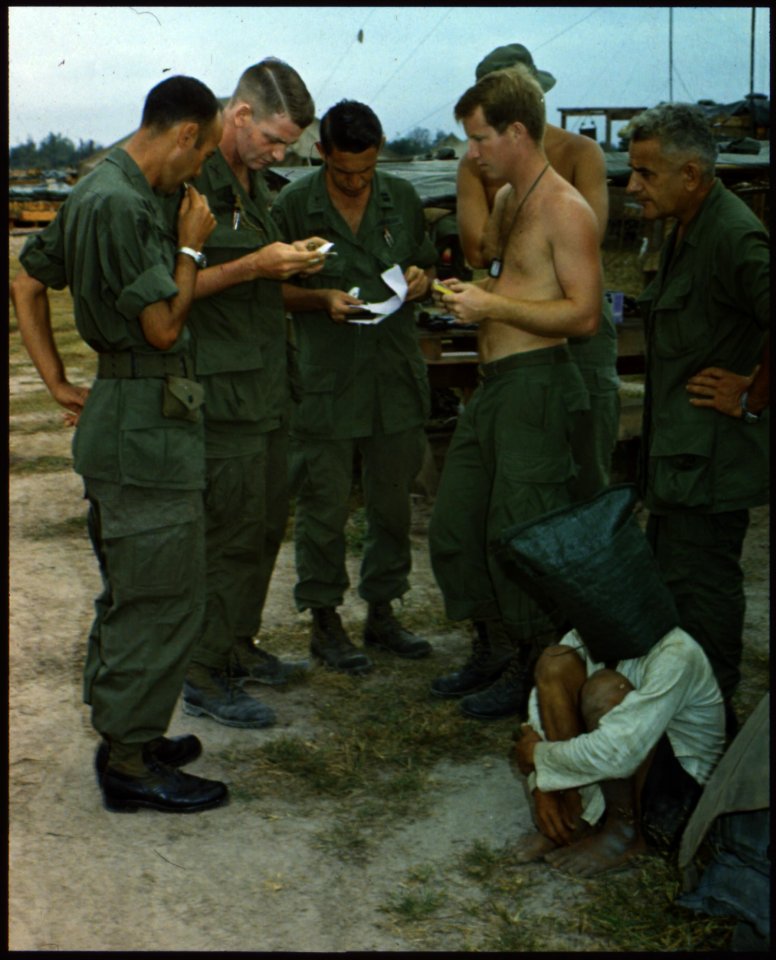 A Viet Cong suspect, captured during an attack on an American outpost near the Cambodian border in South Vietnam, is... - NARA - 542340
