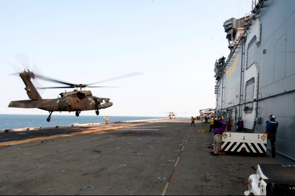 A U.S. Army UH-60L Black Hawk helicopter assigned to the 3rd General Support Aviation Battalion, 2nd Combat Aviation Brigade, 2nd Infantry Division lands aboard the amphibious assault ship USS Bonhomme Richard 140411-N-LM312-043