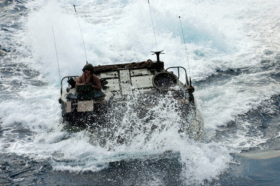 A U.S. Marine Corps assault amphibious vehicle prepares to enter the well deck of the amphibious assault ship USS Bonhomme Richard (LHD 6) in the East China Sea March 11, 2014 140311-N-LM312-198