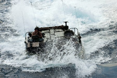 A U.S. Marine Corps assault amphibious vehicle prepares to enter the well deck of the amphibious assault ship USS Bonhomme Richard (LHD 6) in the East China Sea March 11, 2014 140311-N-LM312-198