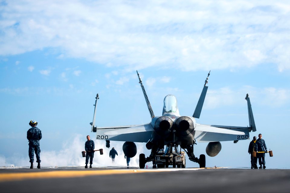 A U.S. Marine Corps F-A-18C Hornet aircraft attached to Marine Fighter Attack Squadron (VMFA) 312 is moved on the flight deck of the aircraft carrier USS Harry S. Truman (CVN 75) in the Persian Gulf March 2 140302-N-ZG705-527