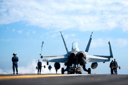 A U.S. Marine Corps F-A-18C Hornet aircraft attached to Marine Fighter Attack Squadron (VMFA) 312 is moved on the flight deck of the aircraft carrier USS Harry S. Truman (CVN 75) in the Persian Gulf March 2 140302-N-ZG705-527