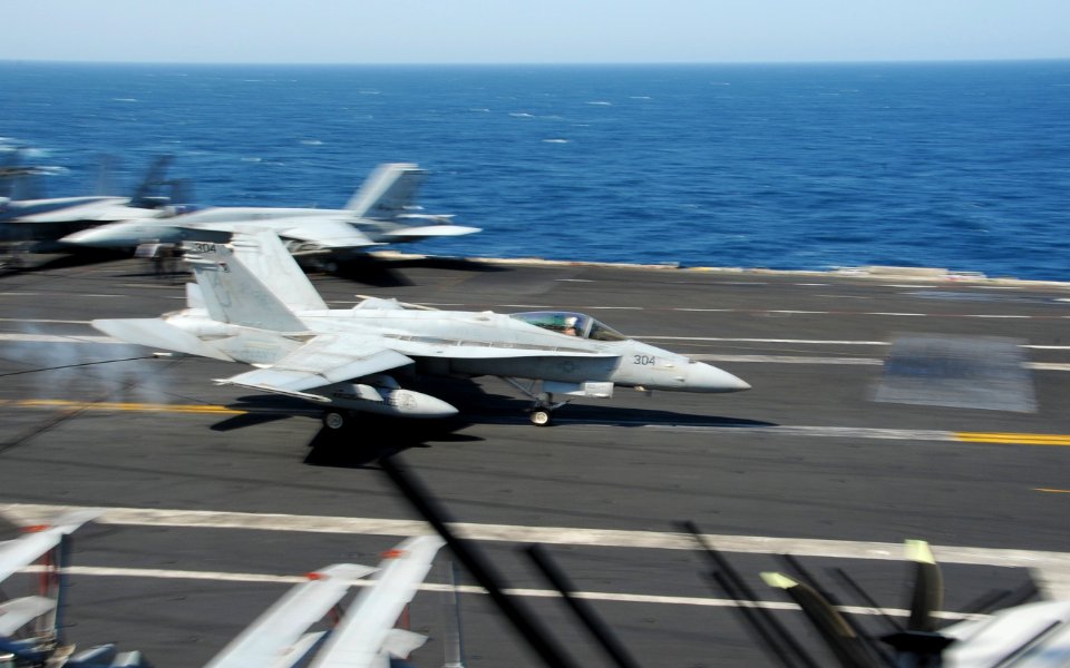 A U.S. Navy F-A-18C Hornet aircraft assigned to Strike Fighter Squadron (VFA) 15 lands on the flight deck of the aircraft carrier USS George H.W. Bush (CVN 77) in the Persian Gulf Aug. 8, 2014 140808-N-MU440-025