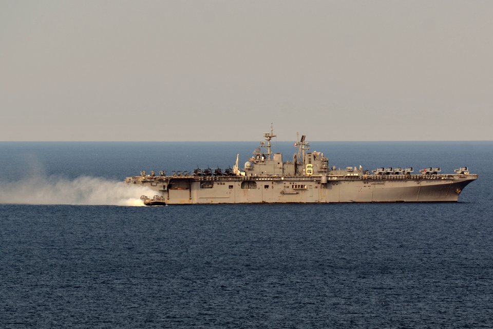 A U.S. Navy landing craft, air cushion assigned to Naval Beach Unit 7 departs the well deck of the amphibious assault ship USS Bonhomme Richard (LHD 6) in the East China Sea April 11, 2014 140411-N-BJ178-122
