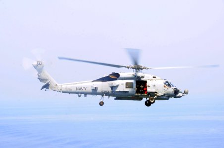 A U.S. Navy MH-60S Seahawk helicopter assigned to Helicopter Maritime Strike Squadron (HSM) 70 flies over the aircraft carrier USS George H.W. Bush (CVN 77) Sept 140902-N-CZ979-001