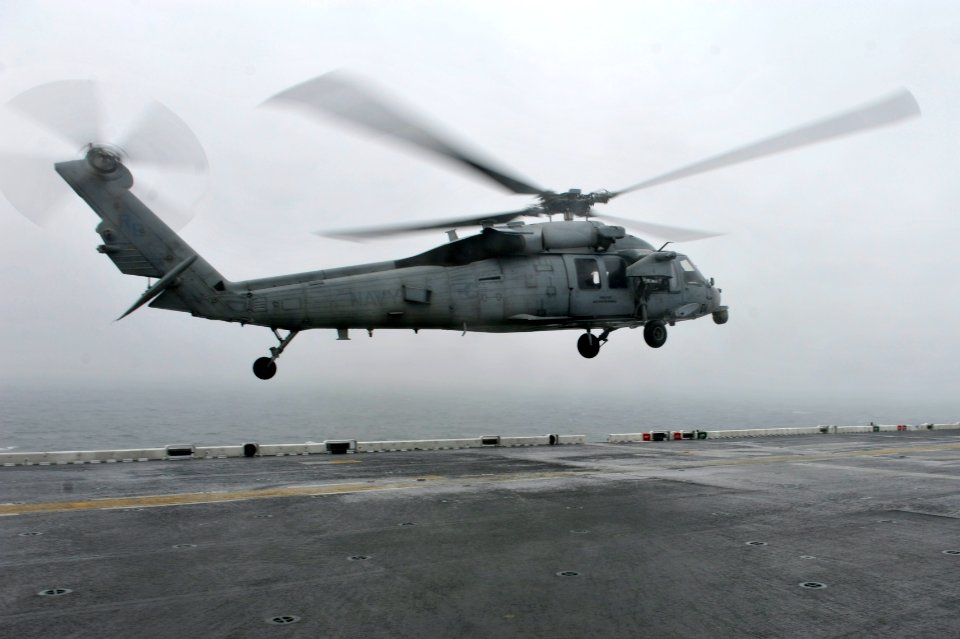 A U.S. Navy MH-60S Seahawk helicopter assigned to Helicopter Sea Combat Squadron (HSC) 25 lands on the flight deck of the amphibious assault ship USS Bonhomme Richard (LHD 6) April 17, 2014, in the East China 140417-N-LM312-003