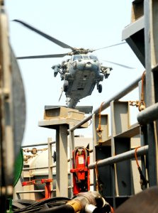 A U.S. Navy MH-60R Seahawk helicopter assigned to Helicopter Maritime Strike Squadron (HSM) 70 prepares to land aboard the aircraft carrier USS George H.W. Bush (CVN 77) in the Persian Gulf Aug. 26, 2014 140826-N-MU440-024