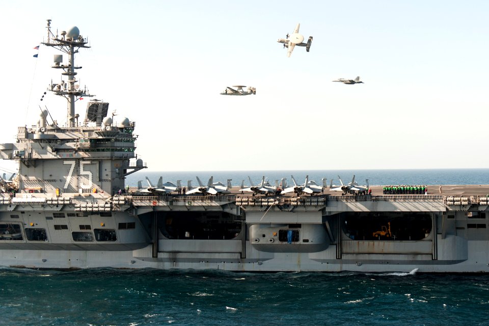 A U.S. Navy E-2C Hawkeye aircraft flown by Cmdr. John Hewitt, top, the outgoing commanding officer of Carrier Airborne Early Warning Squadron (VAW) 126, an E-2C flown by Cmdr. Przemyslaw Kaczynski, left 140318-N-ZG705-051