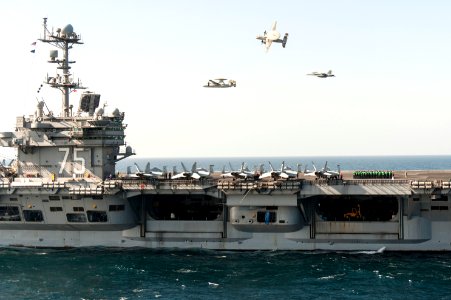 A U.S. Navy E-2C Hawkeye aircraft flown by Cmdr. John Hewitt, top, the outgoing commanding officer of Carrier Airborne Early Warning Squadron (VAW) 126, an E-2C flown by Cmdr. Przemyslaw Kaczynski, left 140318-N-ZG705-051