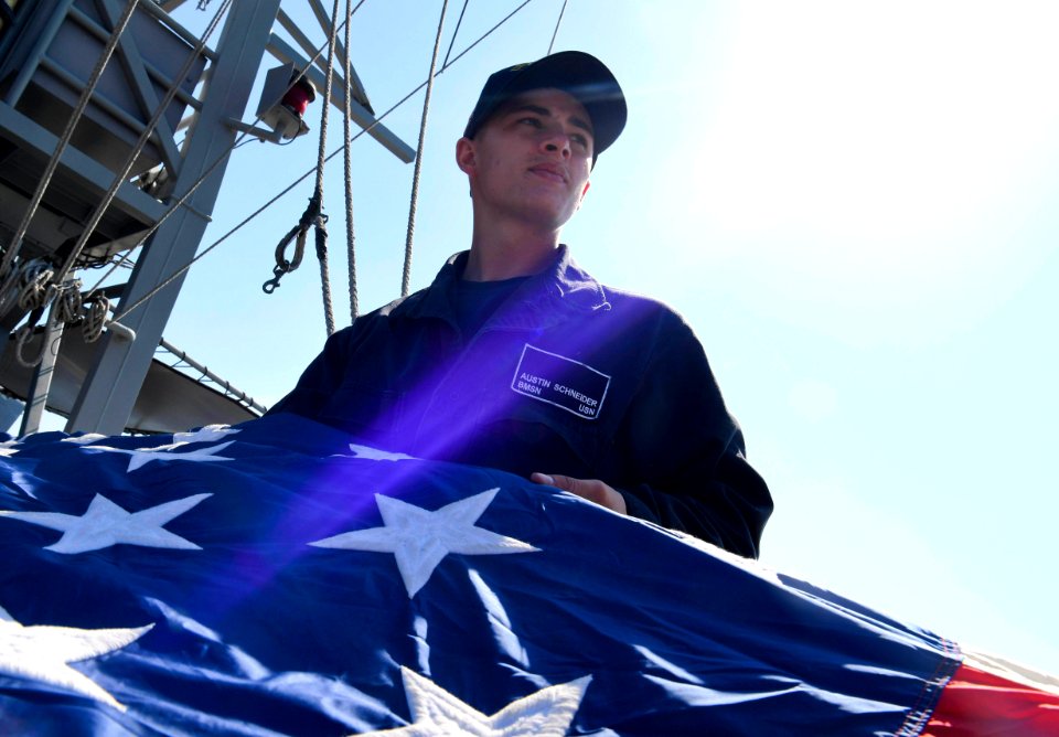 A U.S. Navy Sailor folds a battle ensign. (38492742830)