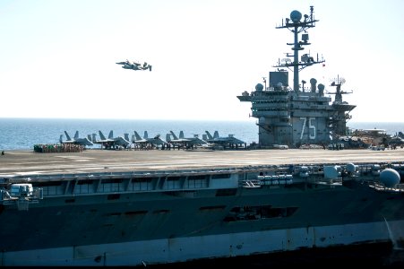 A U.S. Navy E-2C Hawkeye aircraft flown by Cmdr. Przemyslaw Kaczynski, foreground, the incoming commanding officer of Carrier Airborne Early Warning Squadron (VAW) 126, flies beside an EA-18G Growler aircraft 140318-N-ZG705-086