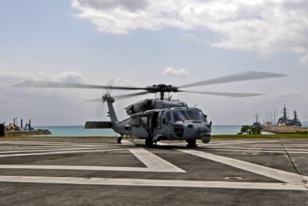 A U.S. Navy MH-60S Seahawk helicopter, assigned to Helicopter Sea Combat Squadron (HSC) 25, prepares to take off from a landing pad at White Beach Naval Facility, Okinawa, Japan, March 14, 2014 140314-N-BJ178-252