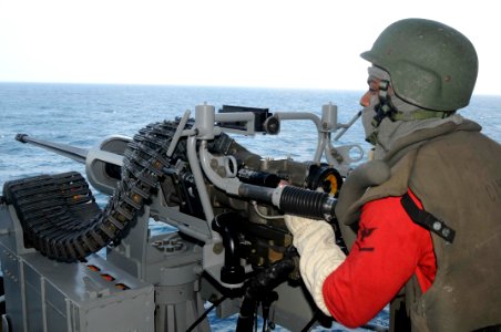 A U.S. Navy sailor mans a 25 mm machine gun during a drill. (8428933159)