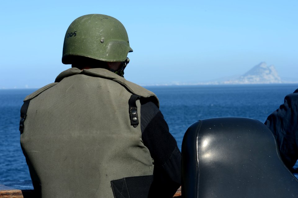 A U.S. Sailor assigned to the small-caliber action team mans his station as the amphibious transport dock ship USS Mesa Verde (LPD 19) transits the Strait of Gibraltar in the Mediterranean Sea Feb. 26, 2014 140226-N-BD629-136