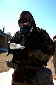 A U.S. Sailor with Naval Mobile Construction Battalion (NMCB) 25 prepares to test air quality with an M256 chemical agent detector kit during a simulated chemical attack during chemical, biological 140214-N-JP566-126