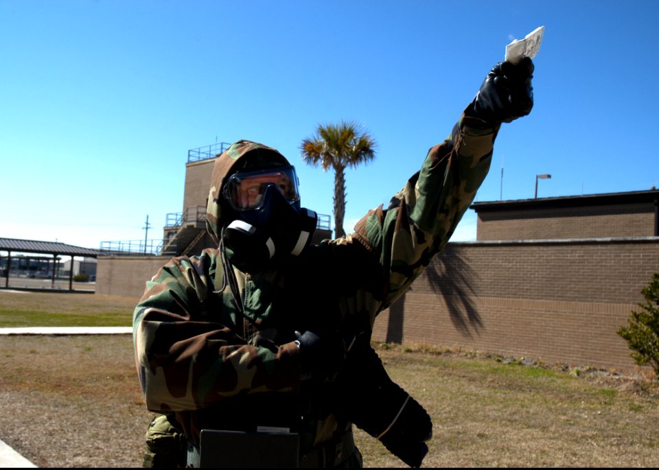 A U.S. Sailor with Naval Mobile Construction (NMCB) 25 tests air quality with an M256 chemical agent detector kit during a simulated chemical attack during chemical, biological and radiological (CBR) team 140214-N-JP566-137