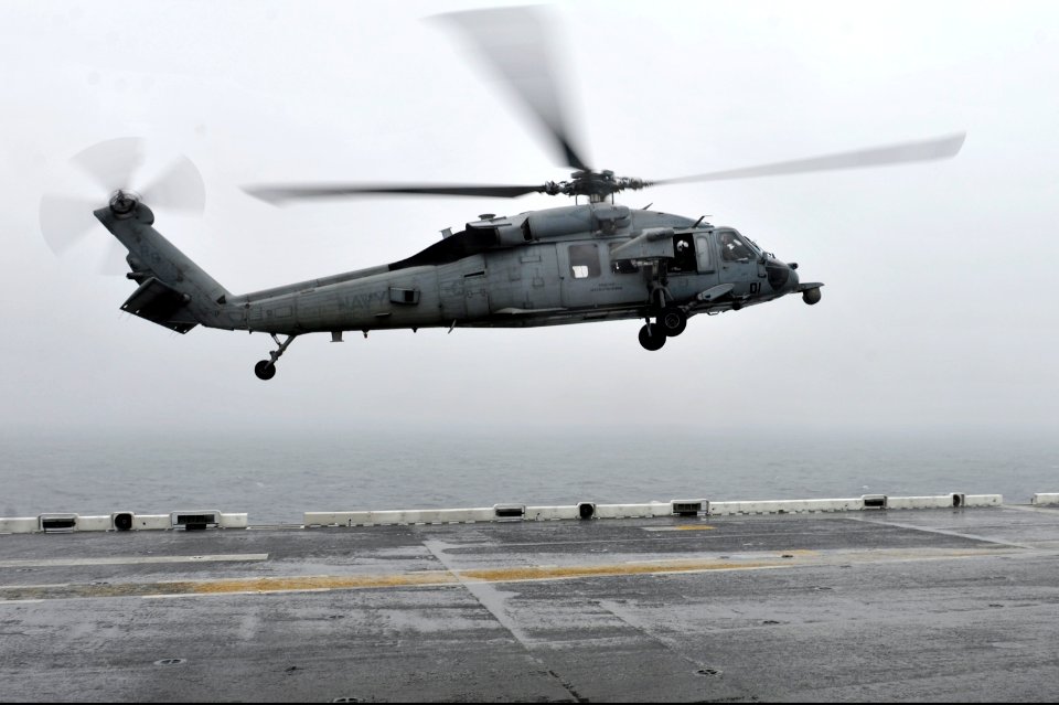A U.S. Navy MH-60S Seahawk helicopter assigned to Helicopter Sea Combat Squadron (HSC) 25 lands on the flight deck of the amphibious assault ship USS Bonhomme Richard (LHD 6) April 17, 2014, in the East China 140417-N-LM312-002