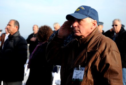 A Veteran salutes during a memorial service aboard USS Enterprise. (8241543740)