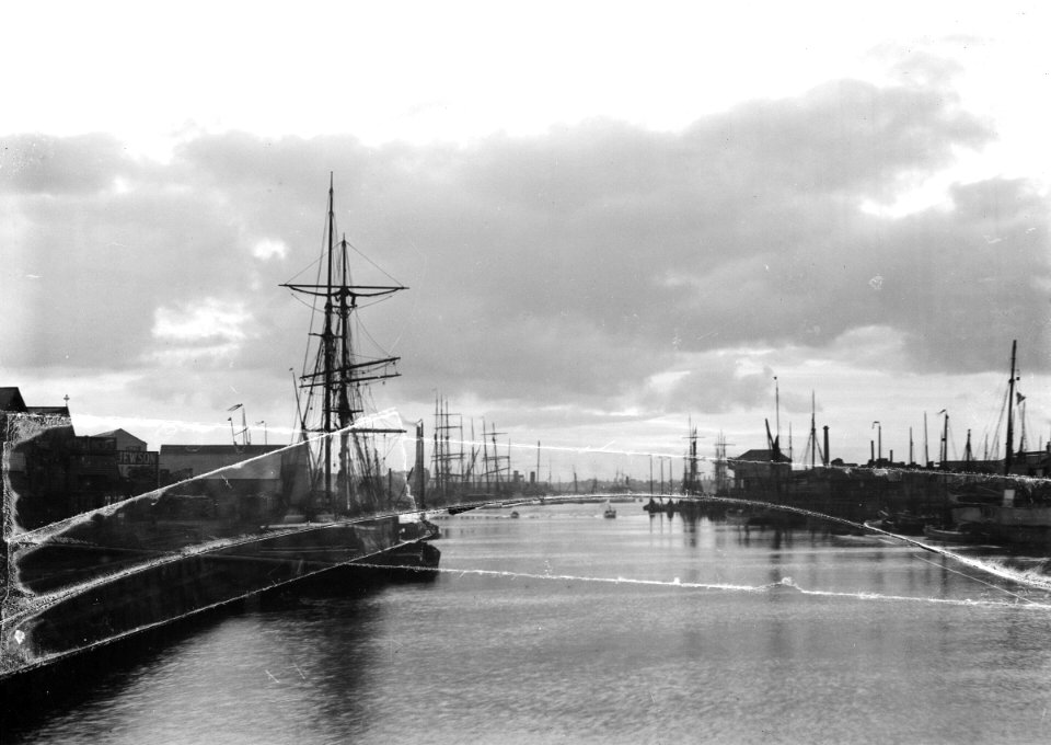 A view of the inner harbour at sunset from the harbour entrance west of the road bridge. RMG P27519